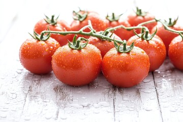 Poster - A group of tomatoes sitting on top of a wooden table, great for food and culinary concepts