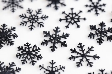 Poster - A close-up shot of a few black snowflakes sitting on a white surface