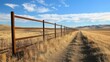 © Suphawan - Perspective shot of a long metal fence stretching into the distance, evoking a sense of restriction.