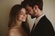 © InfiniteStudio - A young couple in evening attire sharing a warm moment indoors with gentle smiles and soft lighting, creating a romantic atmosphere