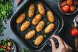 © Kristina - hand cooking homemade croquettes recipe in air fryer at the kitchen top view