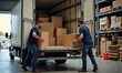 © Ruslan Gilmanshin - Two movers loading cardboard boxes into a delivery truck in a warehouse, representing teamwork, logistics, and efficient transportation