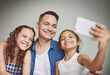 © peopleimages.com - Happy, father and children with selfie at house for photography, bonding together and social media post. Smile, man and kids with embrace of profile picture update, family safety and childhood memory
