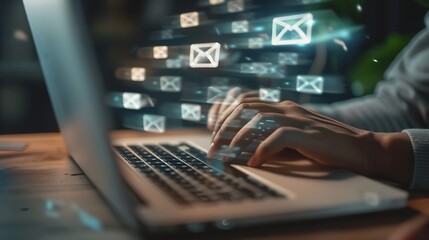 Wall Mural - A person typing on a laptop with digital email icons floating above, symbolizing communication.