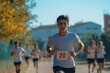 © Gatherina - Young athlete running marathon on athletics track
