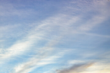 Wall Mural - a beautiful sky tinted by the sun leaving vibrant shades of gold, pink, blue and multicolored. cloud