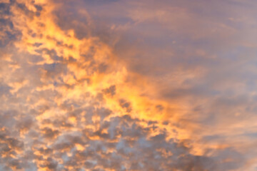 Wall Mural - a beautiful sky tinted by the sun leaving vibrant shades of gold, pink, blue and multicolored. cloud