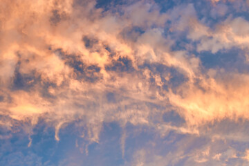 Wall Mural - a beautiful sky tinted by the sun leaving vibrant shades of gold, pink, blue and multicolored. cloud