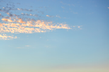 Wall Mural - a beautiful sky tinted by the sun leaving vibrant shades of gold, pink, blue and multicolored. cloud