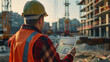 © Hovhannes - Construction worker engineer architect team at work on major construction site with computer tablet hardhat and safety vest.
