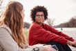 © MACO - Gen Z couple outside beside a river hanging out and having fun together. Munich, Germany