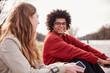 © MACO - Gen Z couple outside beside a river hanging out and having fun together. Munich, Germany