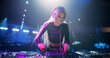 © Gorodenkoff - Stylish Girl Performing at a DJ Concert Live on Stage. Talented Music Producer Dancing, Mixing Energetic Dance Hits on Turntables. Young Beautiful Female Engaging with the Crowd