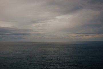 Wall Mural - raining sunset sky over the atlantic ocean, tenerife. minimalism. misty dusk in the sea. dramatic vi