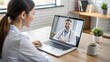 © Tekin - Doctor Video Conferencing With Female Colleague On Laptop