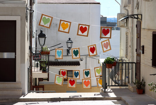 Hearts hanging in the streets of the historic center of Palagianello, Taranto, Puglia, Italy