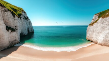 A pristine, sandy beach lies between two towering white cliffs under a bright blue sky, offering a peaceful and scenic escape by the turquoise ocean.