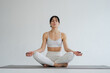 © Юлия Завалишина - Yoga mindfulness meditation. Healthy woman practicing yoga isolated on white background. Woman sitting in lotus pose meditating relaxing. Girl doing breathing practice. Yoga on white background