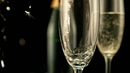 Fototapete - Super Slow Motion of Pouring Champagne Wine on Black Background with Flashing Blur Spot Lights. Filmed on High Speed Cinema Camera, 1000fps. Speed Ramp Effect.