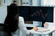 © InfiniteFlow - Young beautiful Asian businesswoman looking on pc to analyze profitable of exchange stock market graph at modern office. Concept of investing high profit in wealth security in finance. Stratagem.
