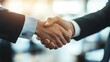 © NFTNexus - Close up image of pleased professionals shaking hands in a business meeting setting