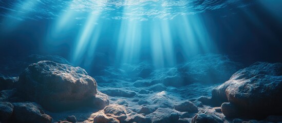 Poster - Underwater sunlight filtering through a rocky ocean floor creating a natural scene with captivating light patterns