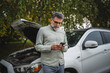 © Miljan Živković - man stand on the road in front open hood and text message for help