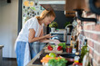 © Geber86 - Young woman cooking healthy vegetables in modern kitchen