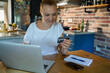 © Geber86 - Woman stressed and frustrated while working on laptop in kitchen