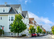 Serene residential street lined with multi-story family homes and trees in Brighton, Massachusetts, USA
