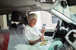 © Davor - Senior nurse eating healthy salad on break in car