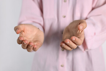 Wall Mural - Man holding something on light background, closeup