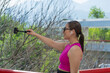 Young Latina woman taking selfie with selfie stick outdoors