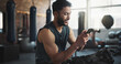 © peopleimages.com - Fitness, gym and man with phone on break for social media, internet and online message. Athlete, happy and person rest with smartphone for mobile app for exercise, training and workout progress