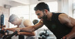 © peopleimages.com - Workout, gym and men with exercise bike, friends and fitness with sweating and strength in health club. Muscle, cardio and training with machine, athlete and equipment with sport and wellness