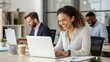 © TimosBlickfang - Smiling Professional Woman Working on Laptop with Colleagues, Collaborative Office Environment, Productive Workday, Modern Workspace, Teamwork and Focus, Digital Technology in the Workplace