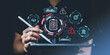 © ImageFlow - Hand holding a stylus over a tablet with futuristic risk management icons such as warning signs, data charts, and safety symbols on a dark background.