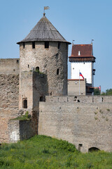 Wall Mural - Gate Tower of Ivangorod Fortress and Long Herman Tower of Narva Castle on a sunny July day. Russia-Estonia border