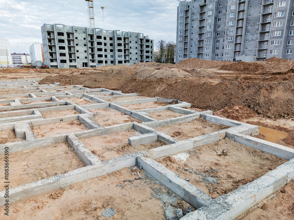 Construction progress at a residential site with foundation structures ...
