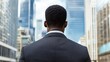 © liliyabatyrova - A man in a suit is standing in front of a city skyline