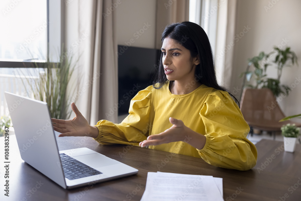 Concerned Indian freelance worker woman looking at wrong working laptop ...