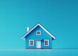 © StokHunt - Blue family home set against a turquoise backdrop, symbolizing real estate transactions such as purchasing, selling, or leasing