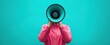 © xiao - Megaphone Speaker with Pink Jacket Against Turquoise Background. Person Communicating with Expression Hidden.