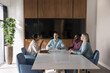 © fizkes - Multiethnic company staff brainstorming on marketing strategy in boardroom, meeting for teamwork, talking at large table. Diverse partners meeting for negotiation, discussing collaboration