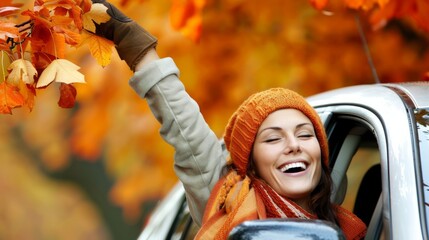 Wall Mural - An excited female tourist was driving alone,  enjoying the freedom of a road trip.   A woman's joy and freedom in autumn shows her love for life and her anticipation  for new adventures.