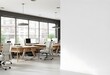 © Stock - A modern office space with large windows, wooden desks, and office chairs. The background is blurred, but appears to be an urban environment.
