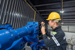 © surachetkhamsuk - Engineer standing by robotic arm and operating machine in industry factory, technician worker check for repair maintenance electronic operation