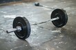© juliars - Black barbell with weights is resting on a gym floor after an intense workout session