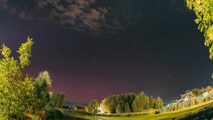 Wall Mural - Rural Countryside Night Sky Time Lapse. Amazing Starry Effects. Meteor Trails On Night Sky Background. Timelapse Night Sky Above River. Star Lines Move In Sky. Amazing Summer Landscape With Reflection