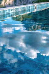 Aufkleber - A still pool of water with a blue tiled wall reflected in it, making it look like one with the sky